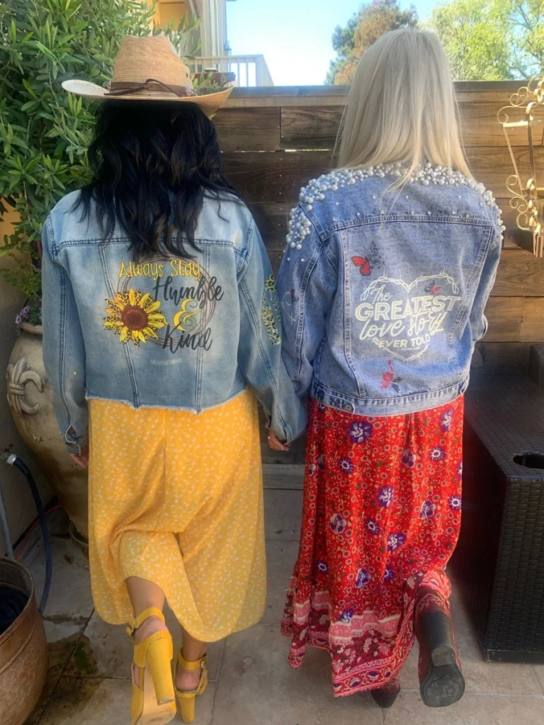 Back of two women in jean jackets and long skirts